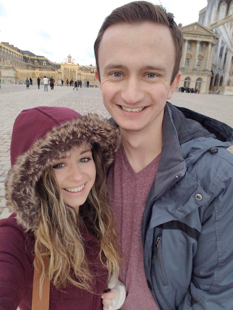 Carrie Cochran and her husband at the Palace of Versailles 