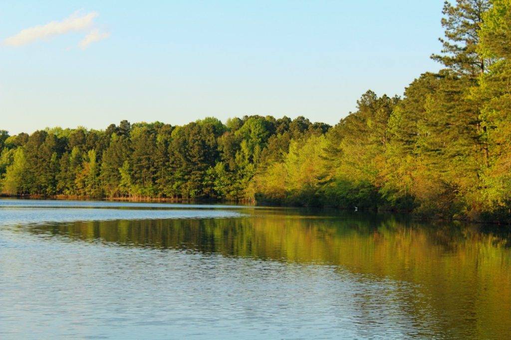 Crystal Lake around dusk with a blue sky and green and yellow trees