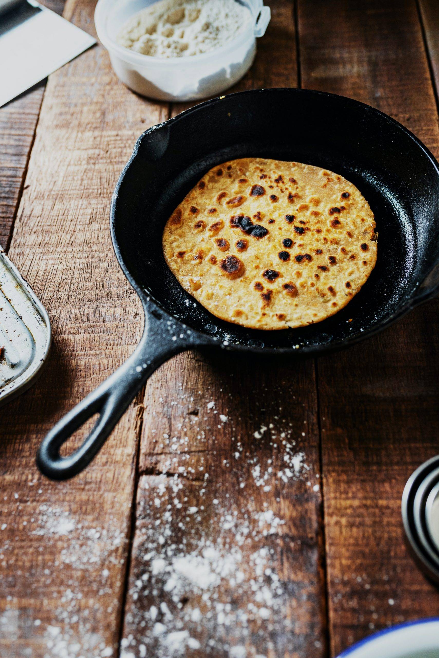 black frying pan on brown wooden table