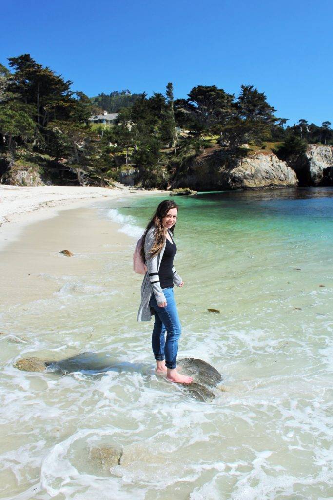 The Mandala Traveler standing in the ocean at Point Lobos
