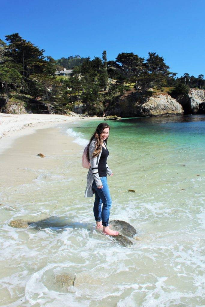 The Mandala Traveler standing in the ocean at Point Lobos