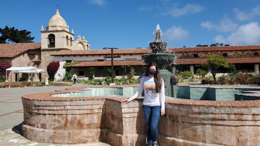 ornate fountain with the carmel mission basilica in the background