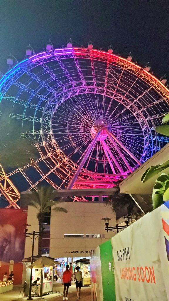 The Icon Wheel: 400-foot talle ferris wheel lit up in neon colors at night time. 