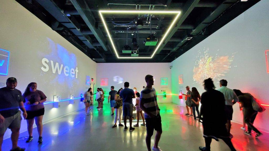 white gallery with multi-colored lights and stations that disperse scents