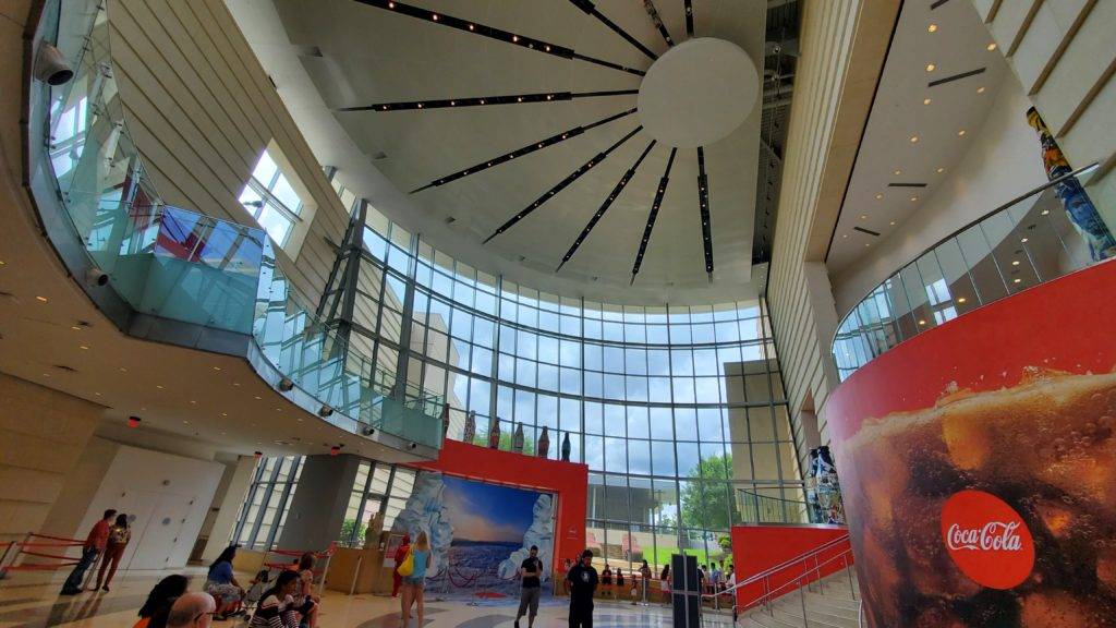 Vaulted ceilngs and glass walls in a large room with a Coca-Cola sign