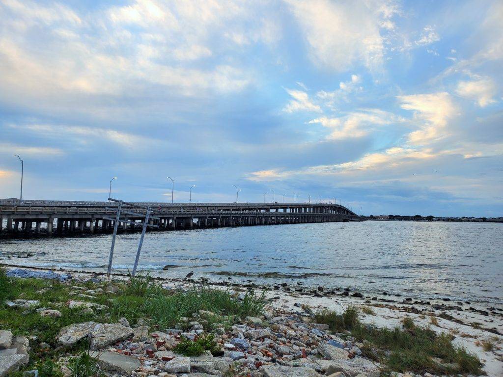 Pensacola Beach bridge and fishin piere around sunset with a heron in the foreground