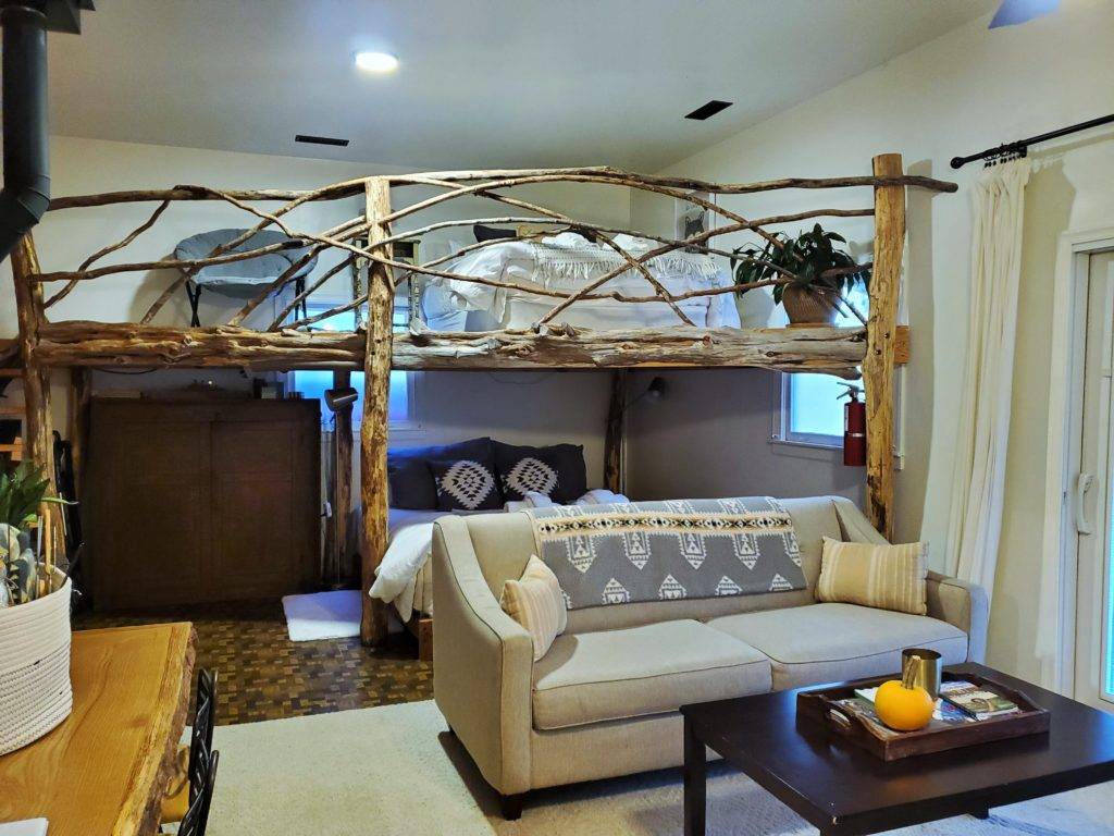 Rustic chic Airbnb one room with sofa and loft bed HeartRock Homestead