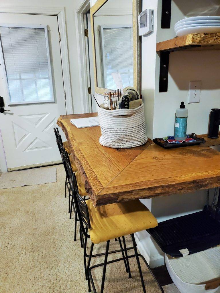 Rustic wood bar with stool seating in HeartRock Homestead