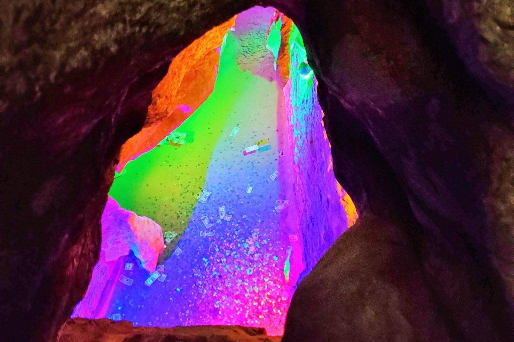 Wishing well with coins and cashing lit up in rainbow colors. Skyline Caverns