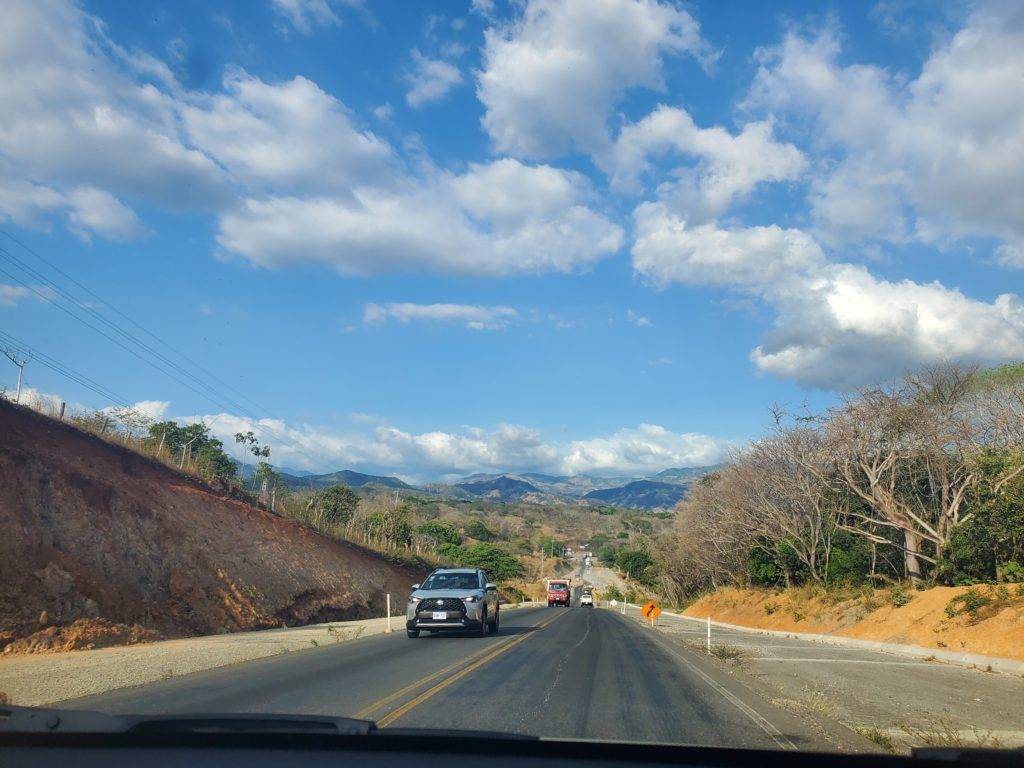 a road in costa rica leading into the mountains