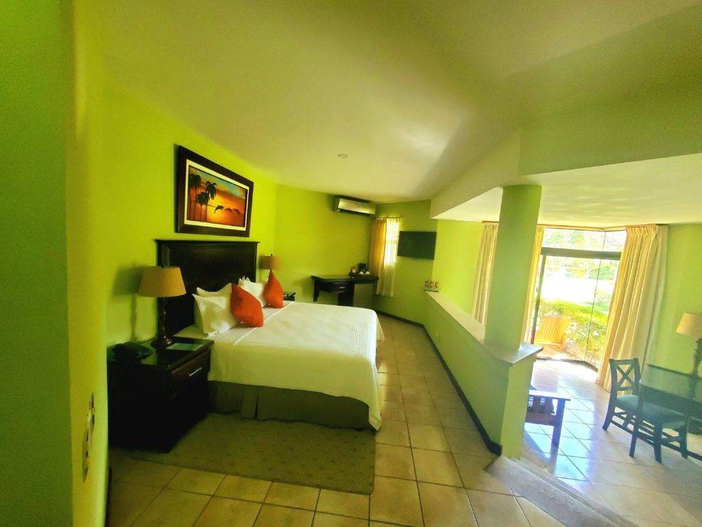 bright green suite with queen bed and tropical decor papagayo golden palms