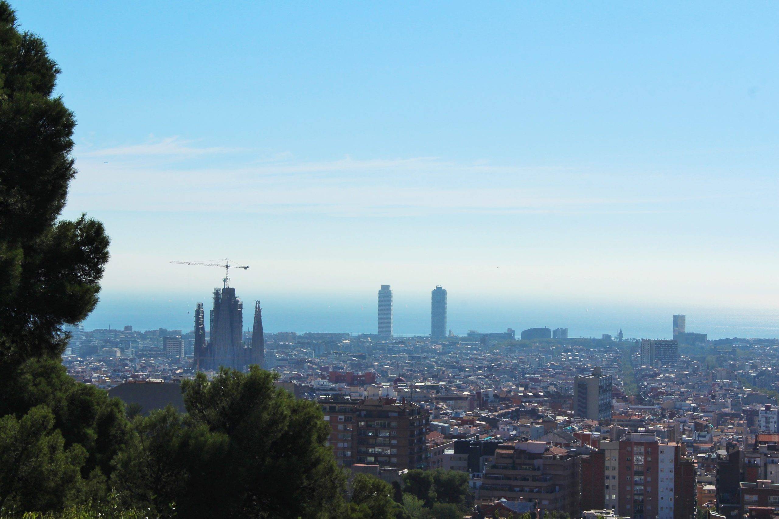 The Barcelona skyline with La Sagrada Familia and the sea in the distance