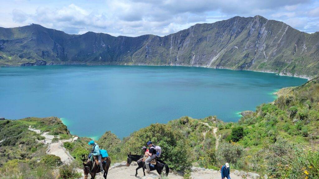 Donkeys and riders ascending the trail from Quilotoa Crater Lake