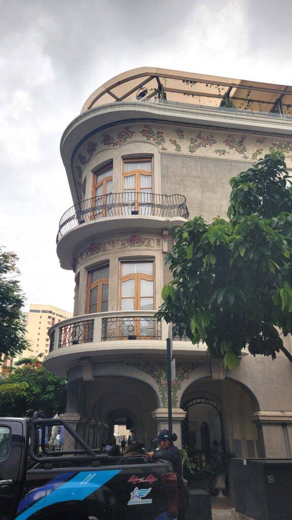 Police officer outside an ornate building with balconies