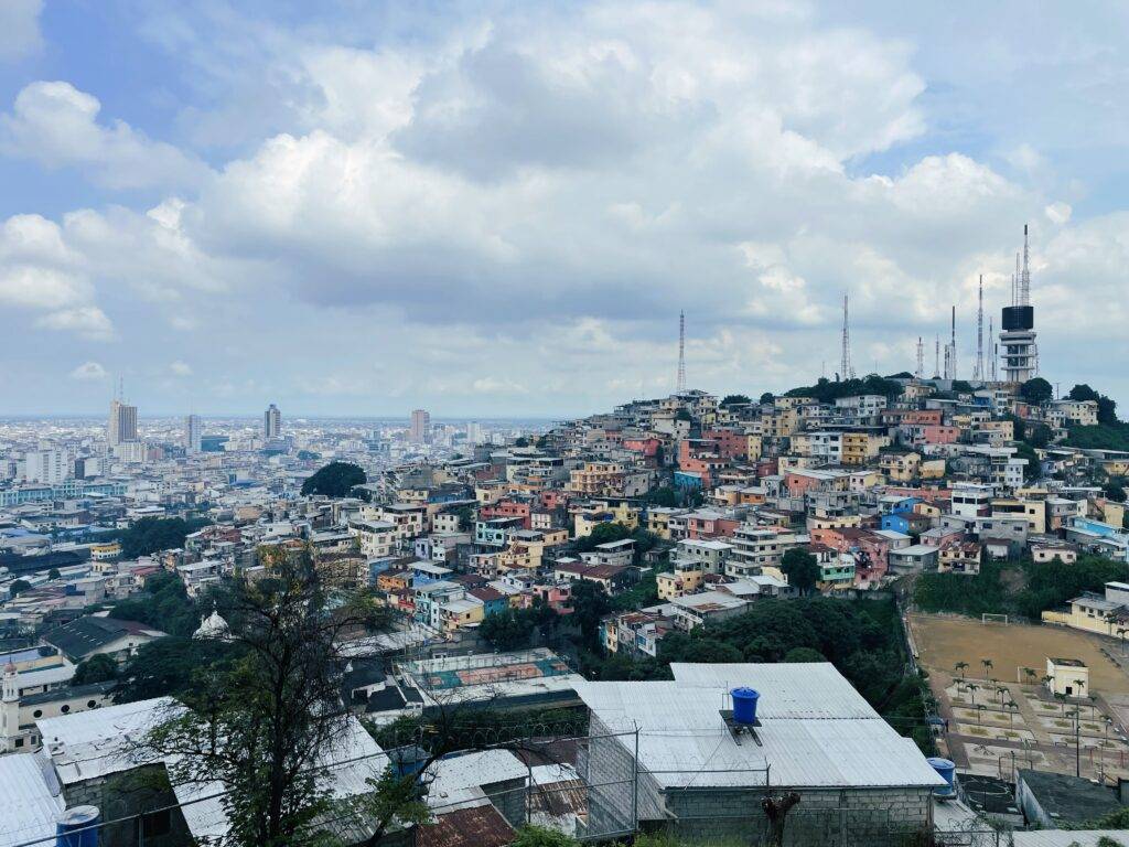 View of Guayaquil from Santa Ana Hill. Colorful wooden houses on a hill with the city beyond