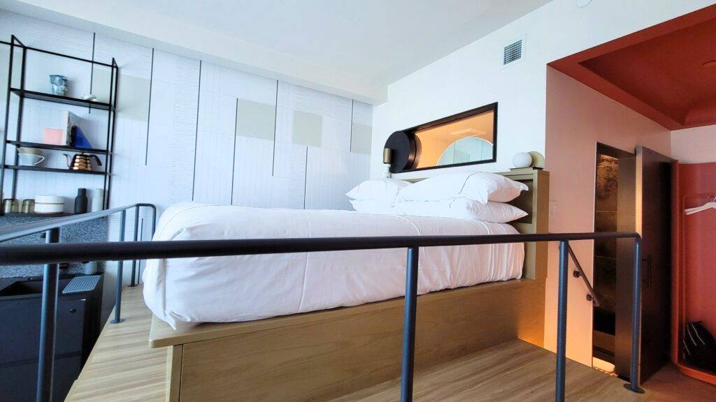 Lofted hotel bed in the Catbird