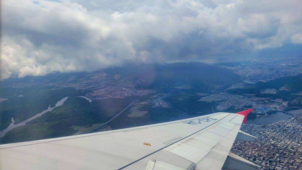 Airplane wing over the city of Guayaquil, Ecuador