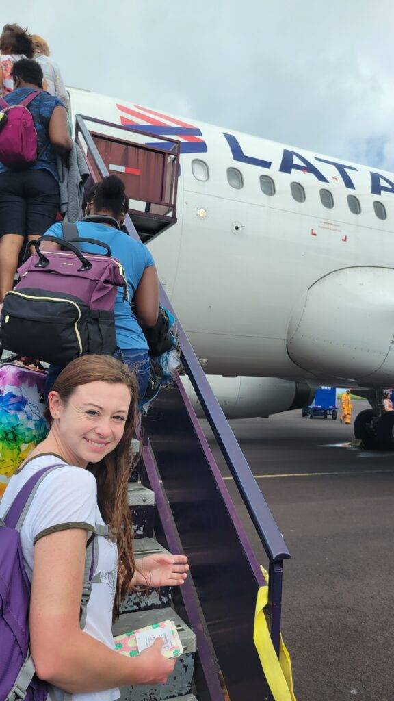 Line of people boarding a LATAM airplane on San Cristobal Island