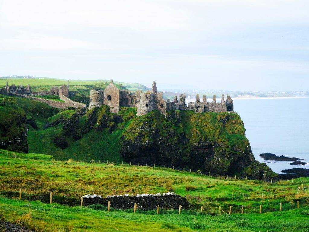 View of Dunluce Castle ruins on a cliff over the ocean
