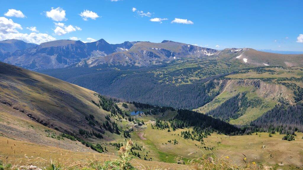 mountains and a small lake on a sunny day