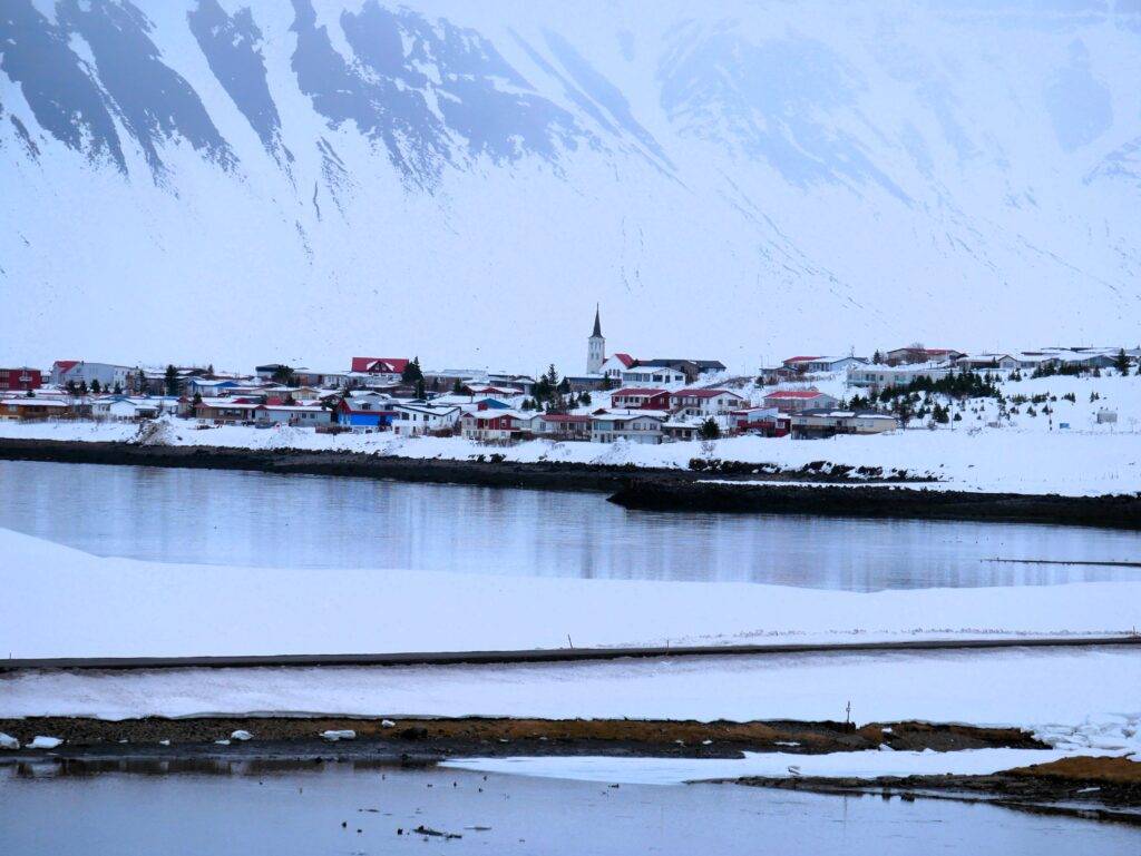 Small Icelandic town with colorful buildings against snow