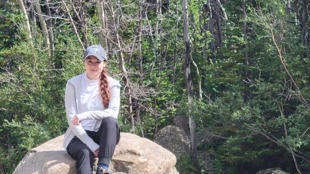 girl in Stelle athleisurewear on a rock