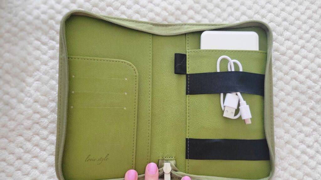 Interior of a passport wallet with phone charger; gifts for travelers