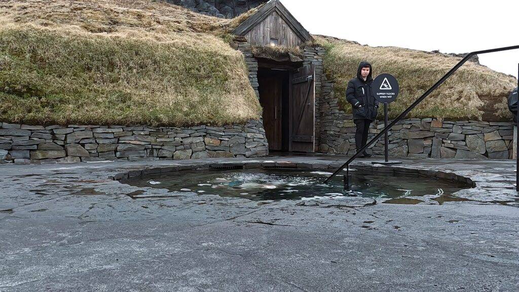 traditional icelandic turf house and a plunge pool
