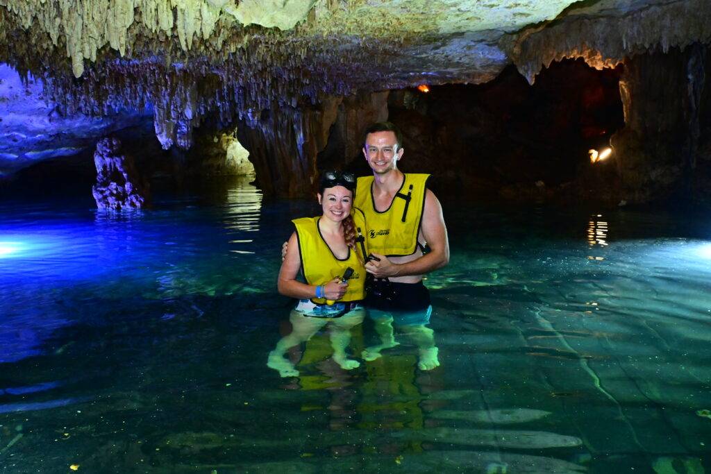 Couple standing in a cenote for the Tulum Xtreme tour