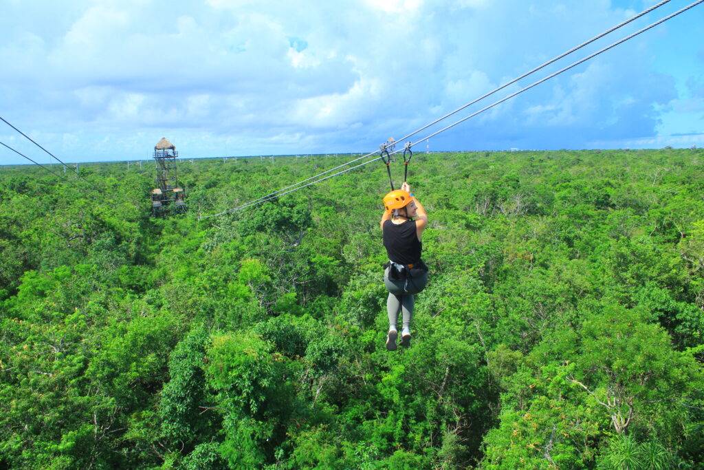 girl ziplining in Tulum, Mexico on Tulum xtreme