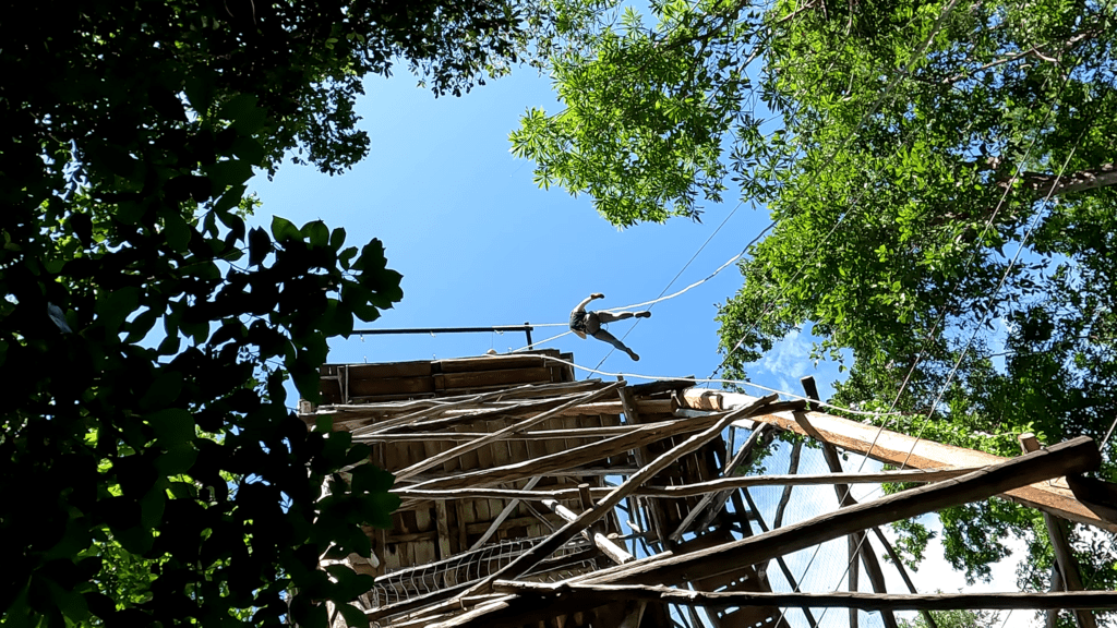 Woman rappelling off a tower at Tulum Xtreme