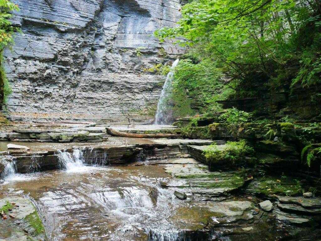 Plunge waterfall pouring into a small pond