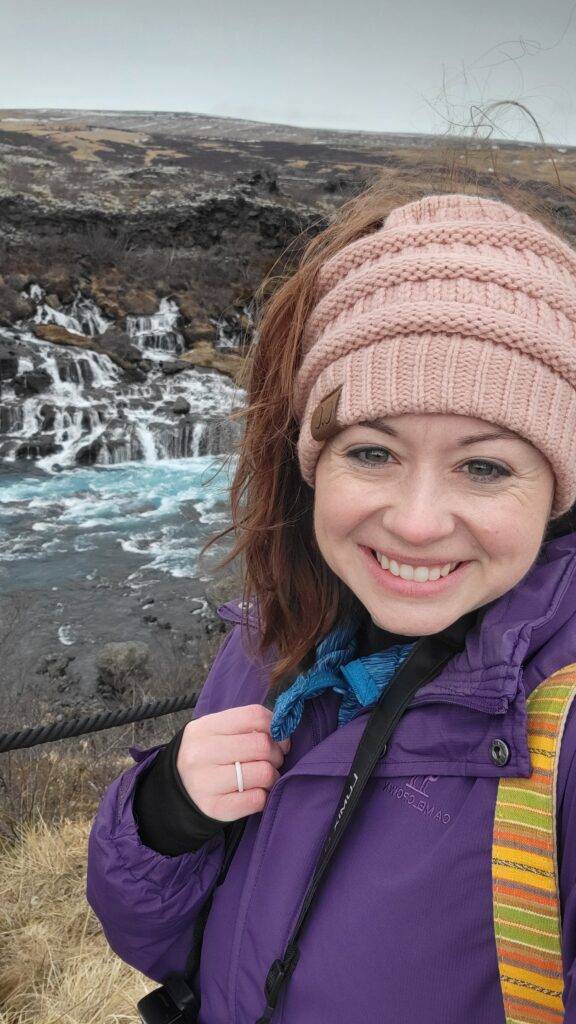 Girl wearing a CC Beanie by Hraunfossar Waterfall in Iceland