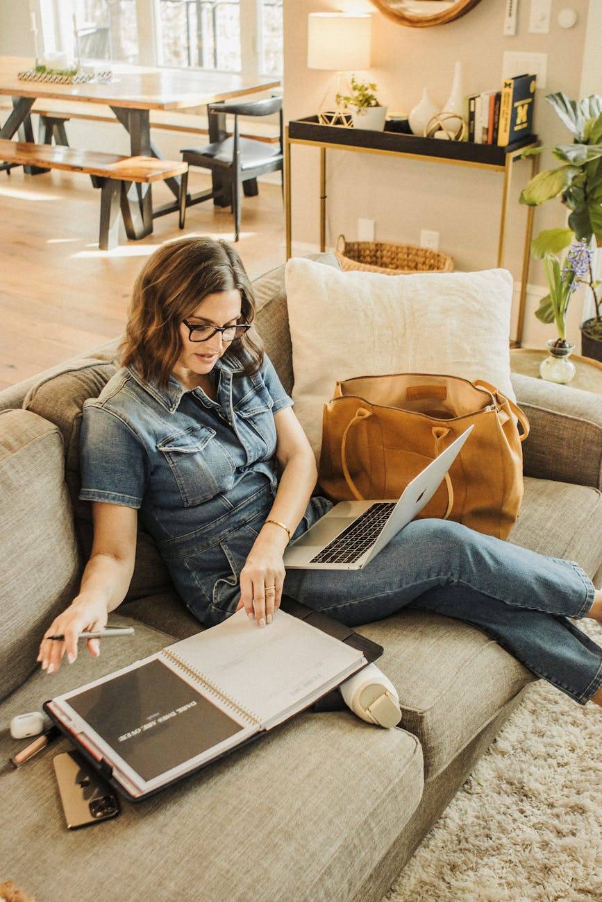 woman working comfortably at home with laptop and planner