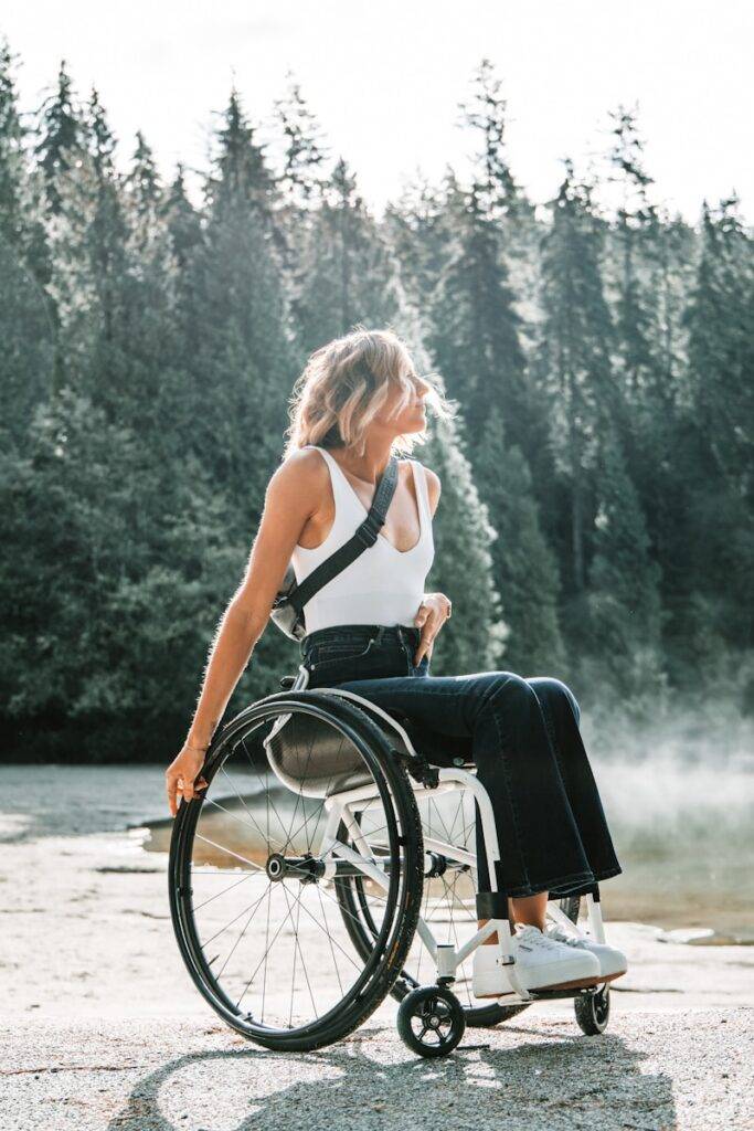 woman riding wheelchair near trees digital nomad with disability