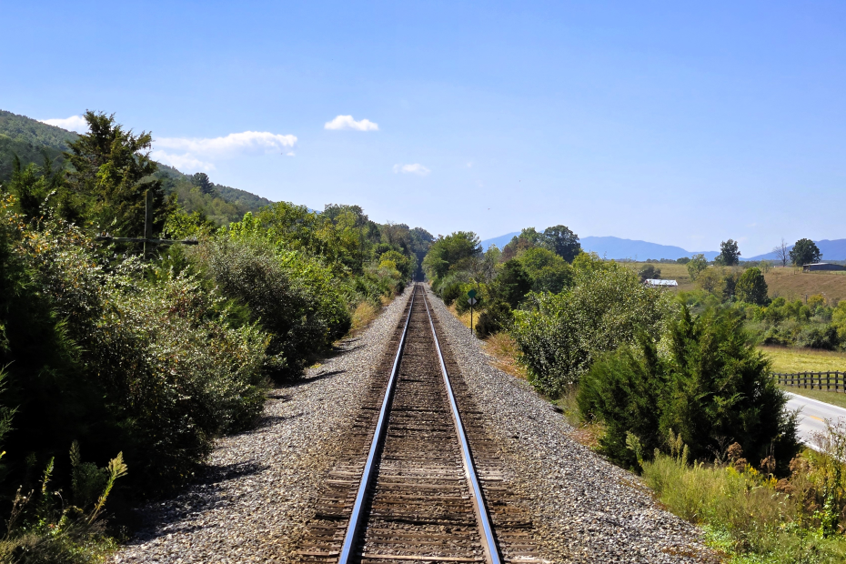 train tracks going off into the distance with mountains in the background on the Virginia Scenic Railway